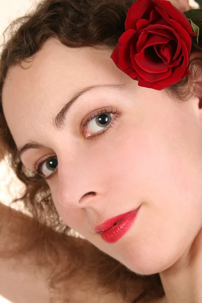 Woman with rose in hair — Stock Photo, Image