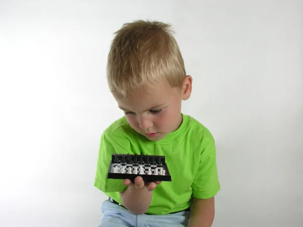 Çocuk satranç üzerinde olduğunu düşünüyor. — Stok fotoğraf