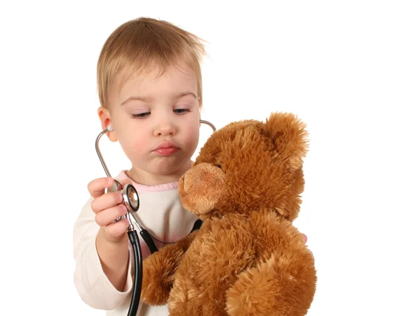Baby mit Stethoskop und Spielzeug lizenzfreie Stockfotos