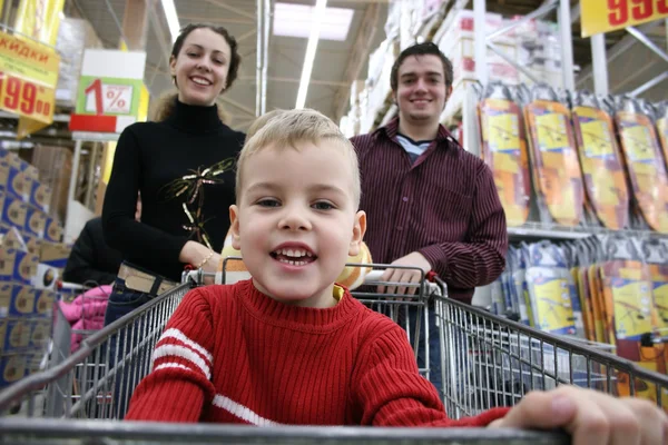Boy with parents in shop — Stock Photo, Image
