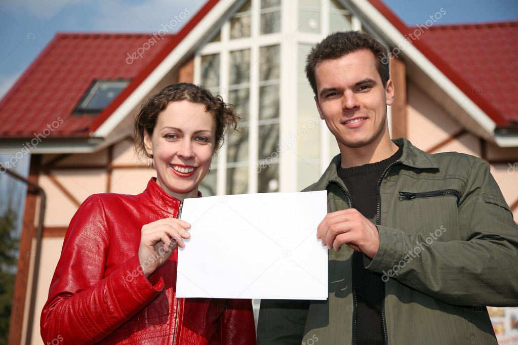 Couple with card and house