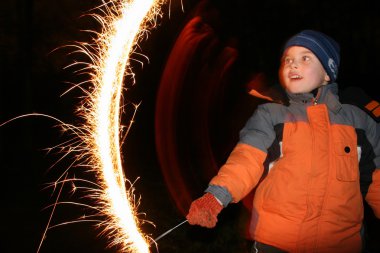 Child with moving sparkler clipart