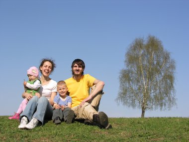 Sitting family with two children. spring. clipart