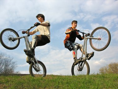 Two Mountain Bikers on second weels clipart