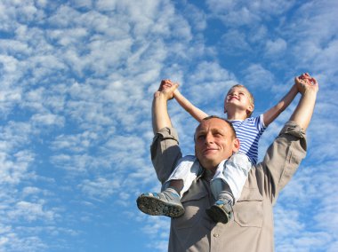 Grandfather with grandson under cloudfield clipart