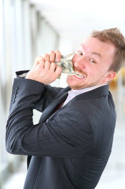 Hungry angry businessman with money clipart