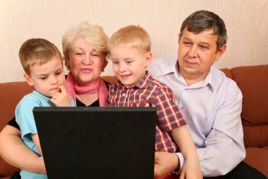 Grandparents with grandchildren with notebook clipart