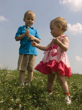 Children on meadow clipart