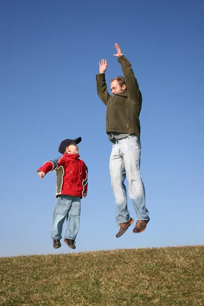Jumping father with son — Stock Photo, Image
