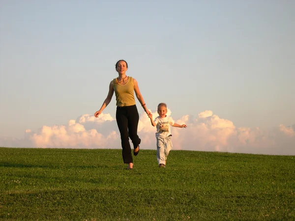 Running mother with son clouds — Stock Photo, Image