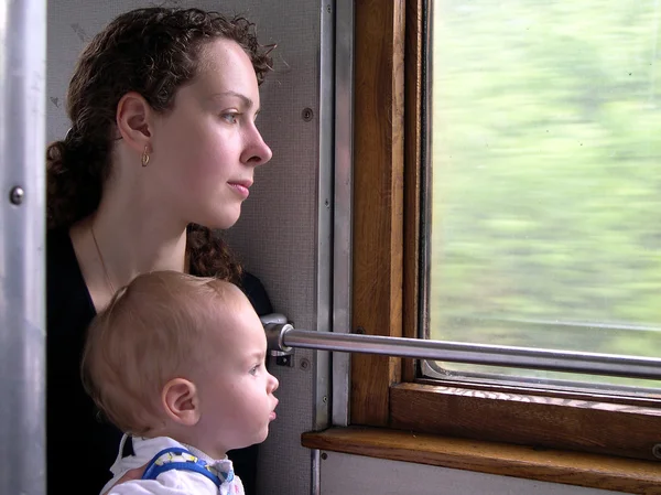 Viajantes espreitam pela janela do comboio — Fotografia de Stock