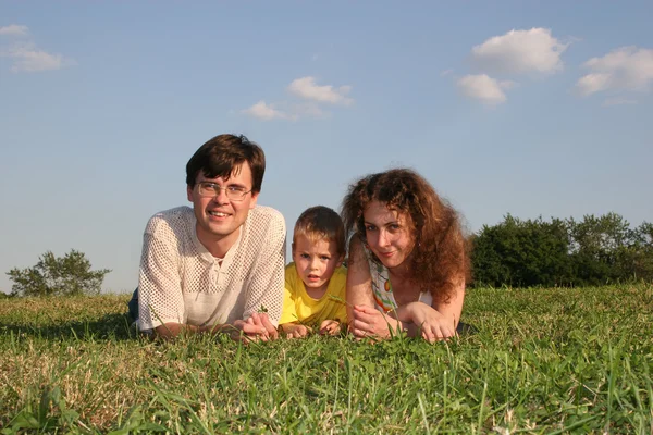 Family lies on meadow — Stock Photo, Image