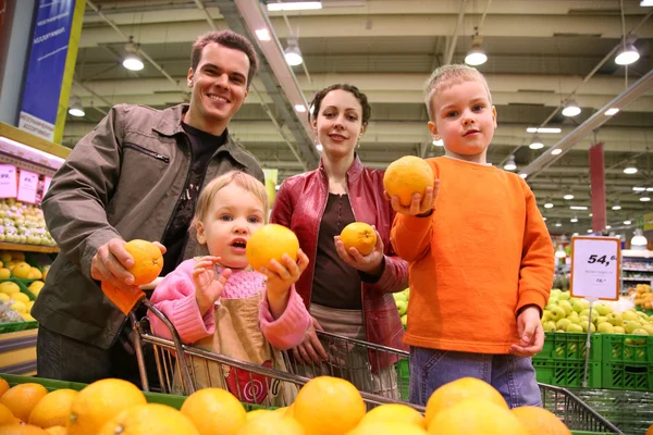 Familie met sinaasappelen — Stockfoto