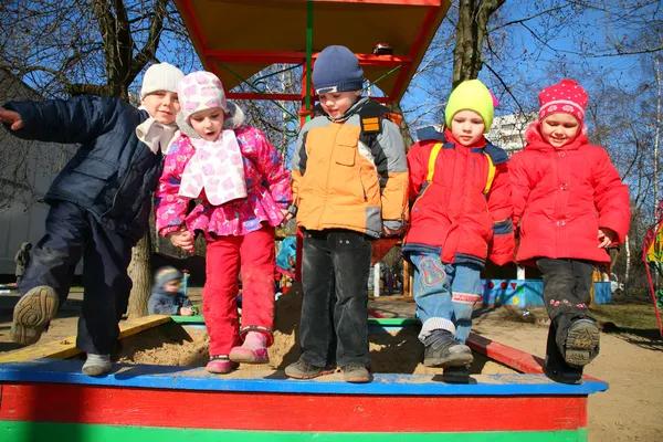 Team with leg up in kindergarten — Stock Photo, Image