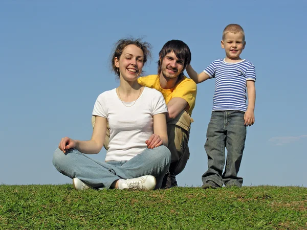 Rodina na trávě sedí — Stock fotografie