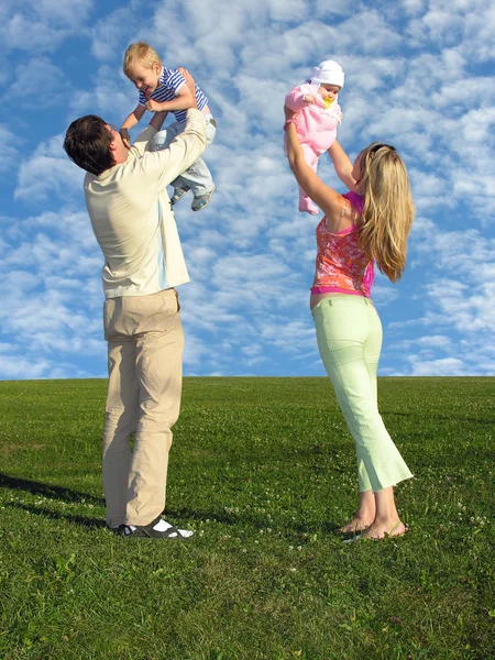 Family with two children and cloudfield — Stock Photo, Image