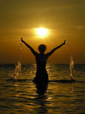 Woman at sunrise with drops of water clipart