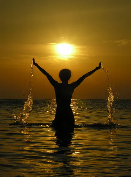 Woman at sunrise with drops of water — Stock Photo, Image