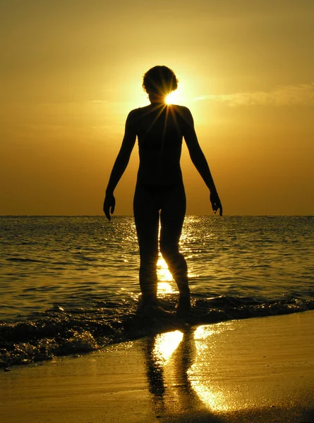 Woman at sunrise with sun in head — Stock Photo, Image