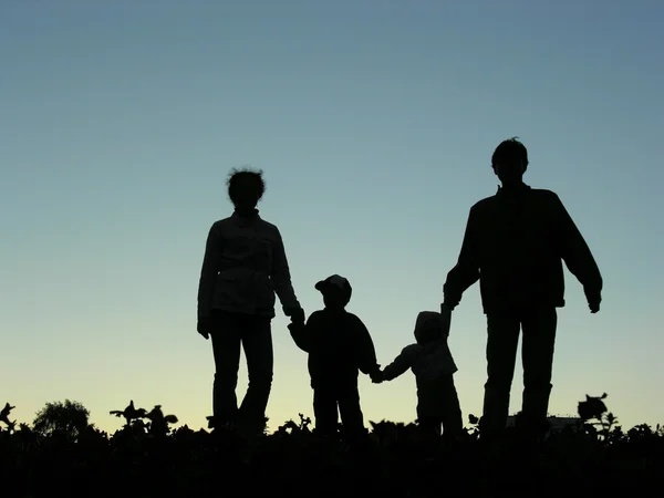 Família de quatro por do sol — Fotografia de Stock