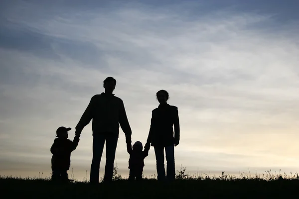 Family of four on sky — Stock Photo, Image