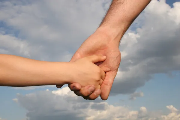 Father's and son's hands Stock Image