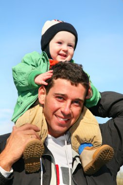 Baby on father's shoulders clipart