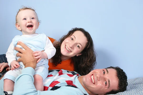 Happy family on bed — Stock Photo, Image