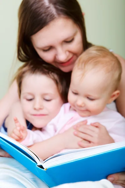 Family reading in bed Stock Picture