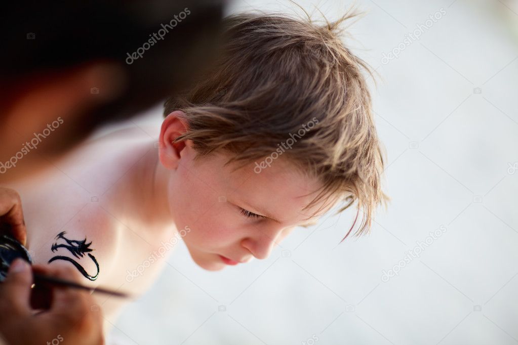 Boy having henna tattoo