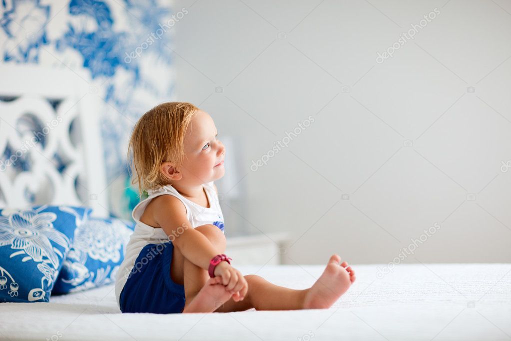 Adorable toddler girl in bedroom