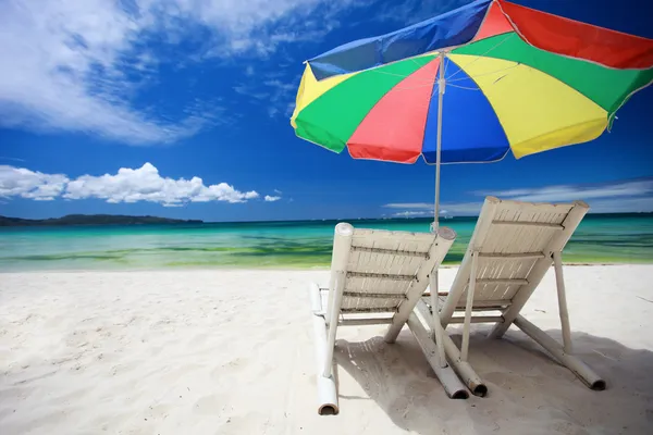 Two beach chairs and colorful umbrella — Stock Photo, Image