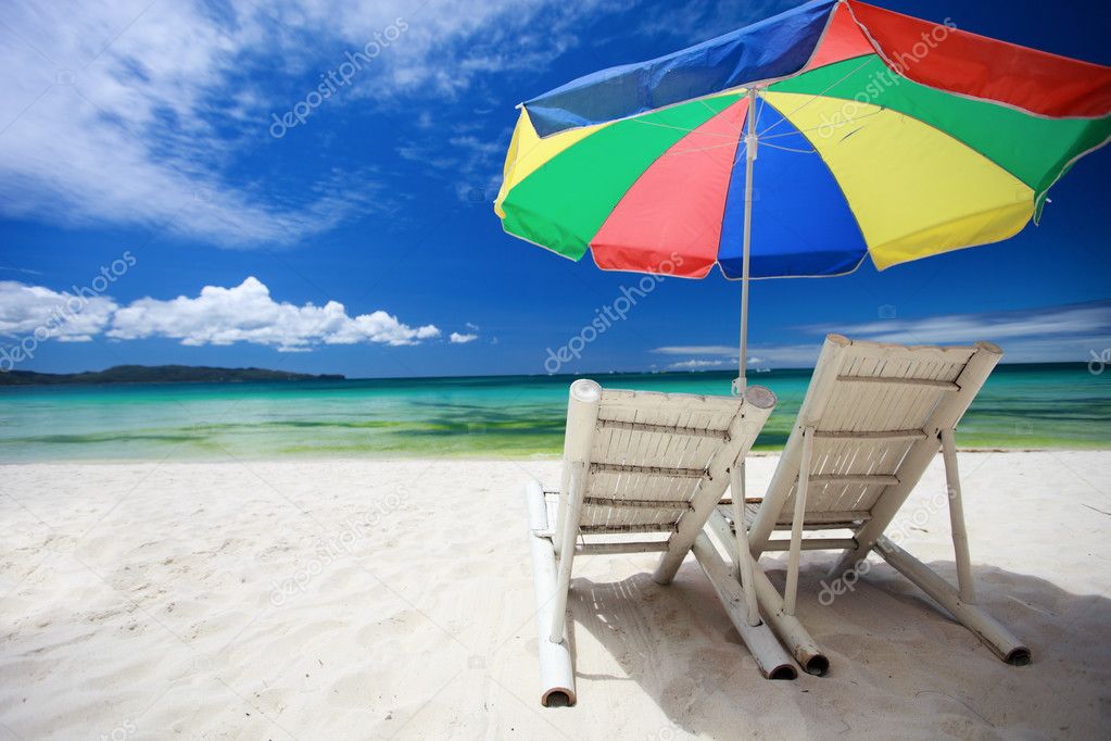 Two beach chairs and colorful umbrella