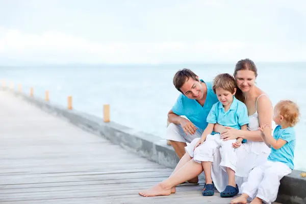 Famille assise à l'extérieur au bord de la mer — Photo