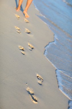 Footprints on tropical beach clipart