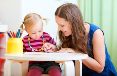 Mother and daughter drawing together clipart