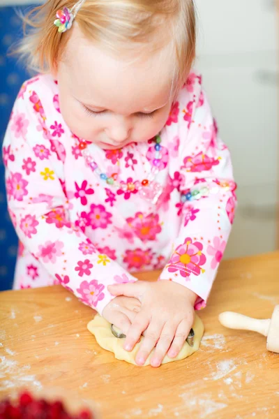 Adorable toddler girl helping at kitchen — Stock Photo, Image