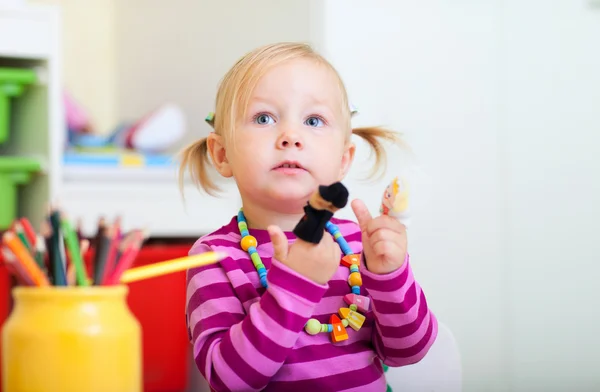 Menina da criança brincando com brinquedos de dedo — Fotografia de Stock