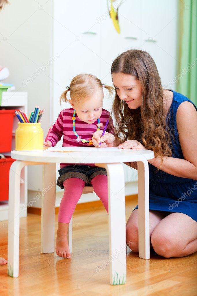 Mother and daughter drawing together