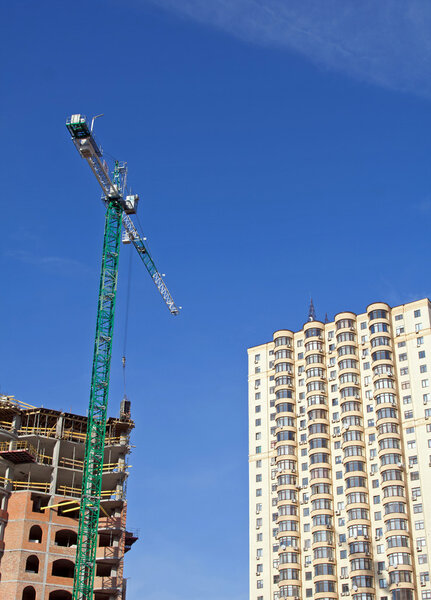 Crane and buildings in blue sky