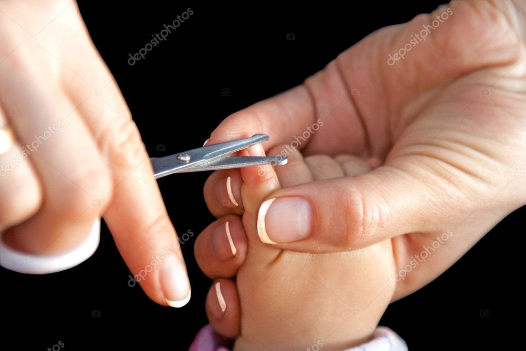 Mother cutting nails with scissors — Stock Photo © aragami12345 2891286
