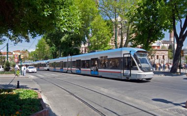 Modern tram on city street clipart