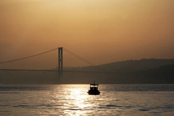 Fishing boat before bridge in Bosporus — Stock Photo, Image