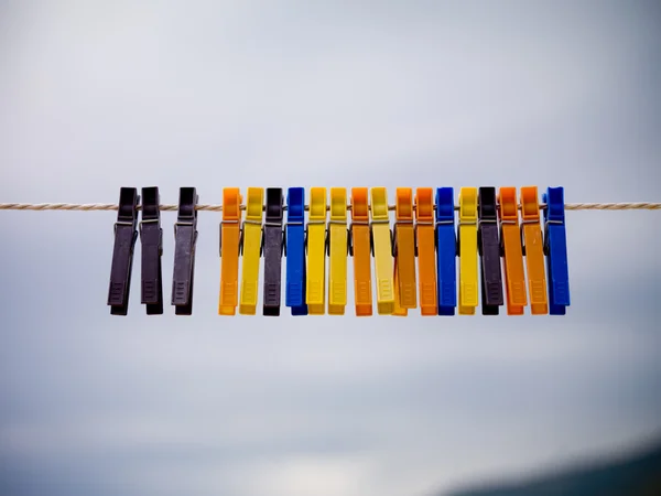 Clothespins hanging oposite sky — Stock Photo, Image