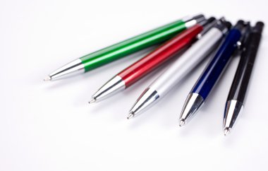 Colored pens on table clipart