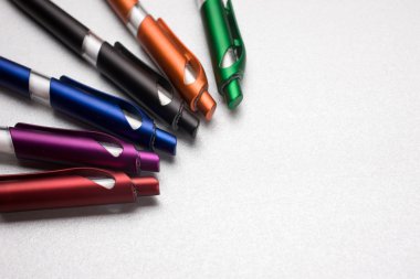 Set of colored pens on table clipart