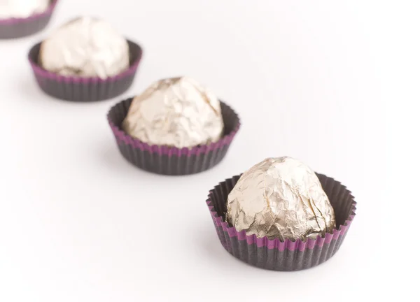 stock image Choco candies in golden foil on table