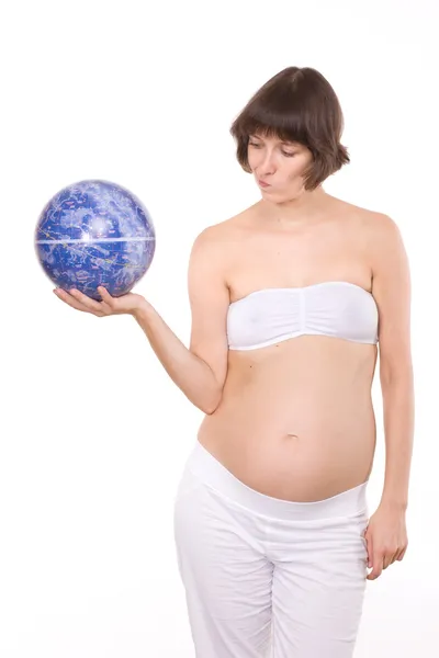 Pregnant woman look on globe — Stock Photo, Image