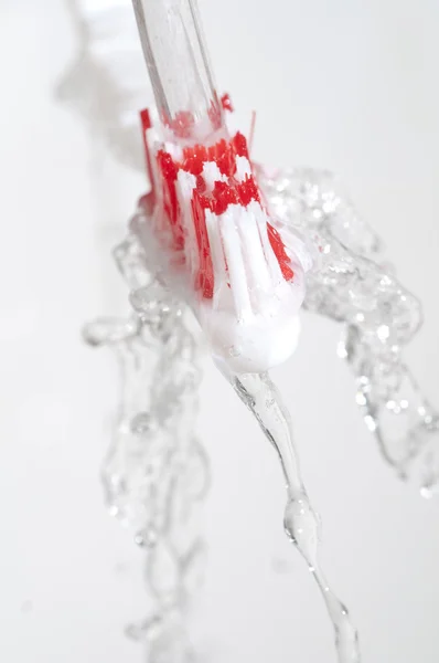 Toothbrush in a water splash — Stock Photo, Image