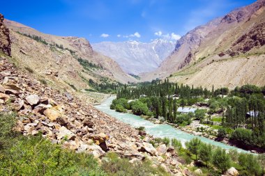 Mountain morraine river under blue sky clipart